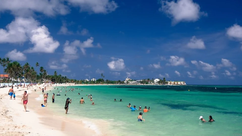 Viajeros disfrutando una playa concurrida de San Andrés
